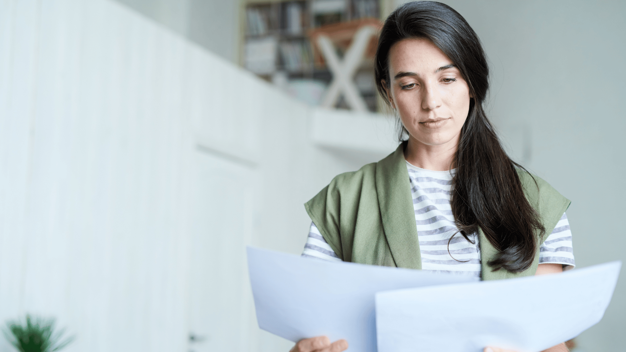 A homeowner carefully reading HOA documents, ensuring compliance with community rules and regulations.