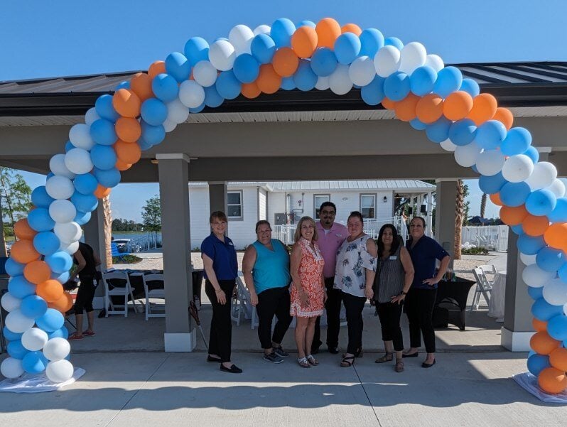 Community celebrating the grand opening of their new clubhouse.