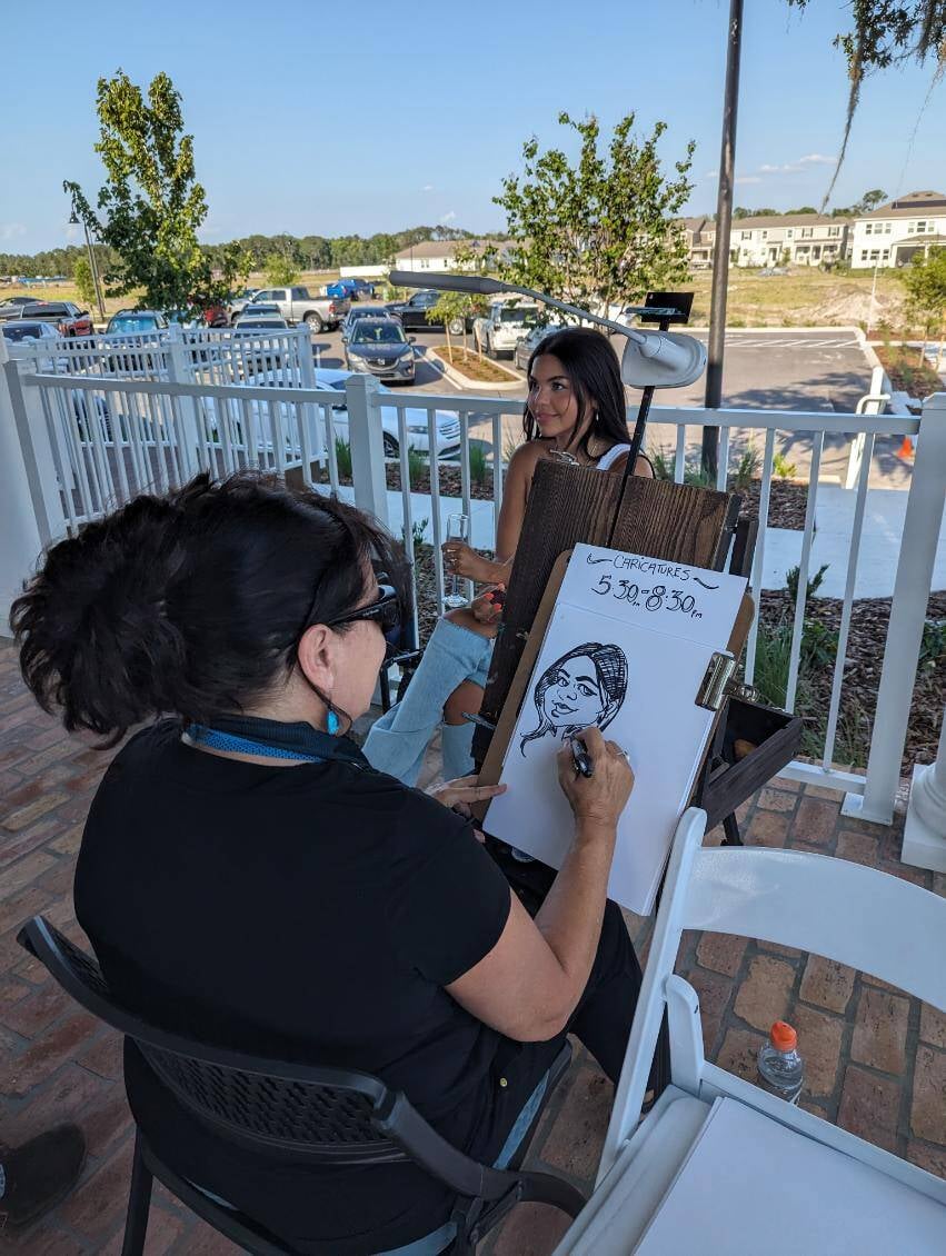 Resident enjoying a caricature portrait at a community event.